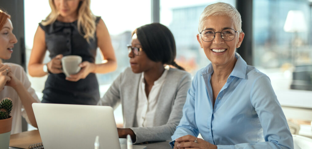 Diverse female employees working together